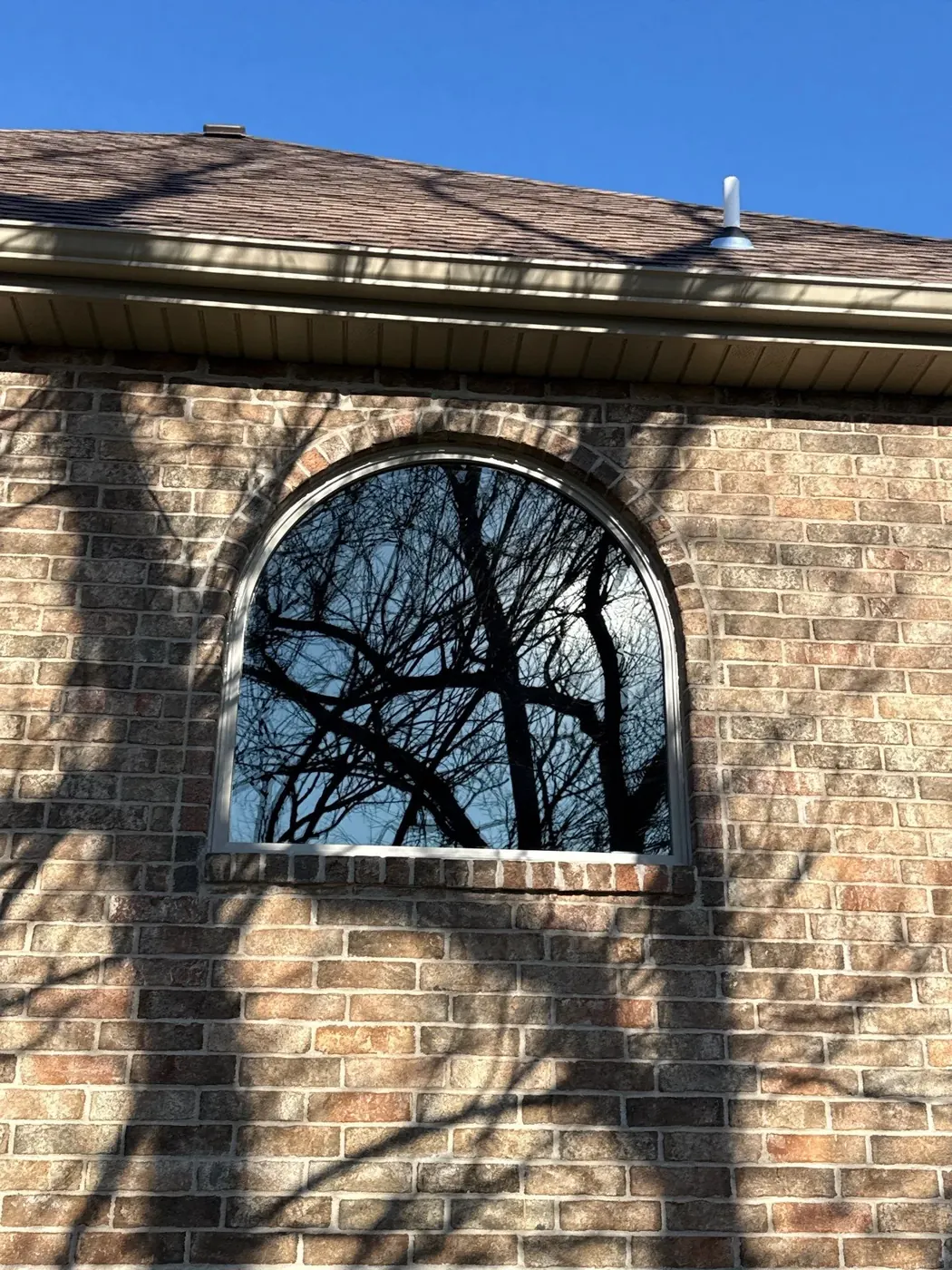 After: the dark replacement window sharpens the arched opening while preserving its character.
